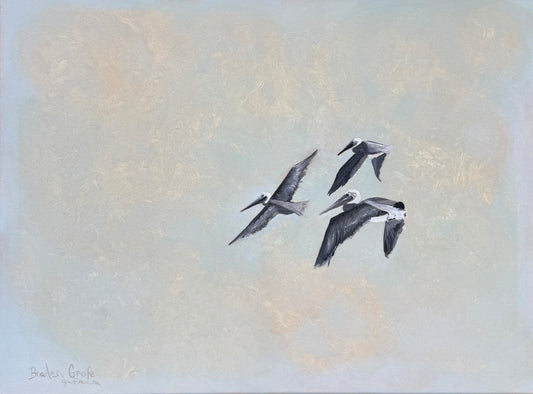Three pelicans flying against a light, textured background